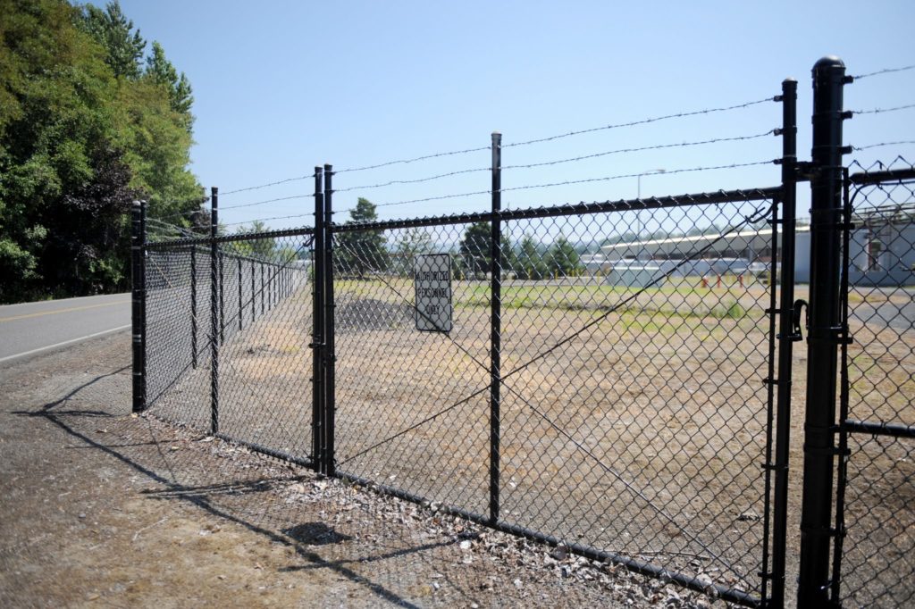 1018 Chain Link Fencing Black Commercial Chain Link Gate featuring barb wire