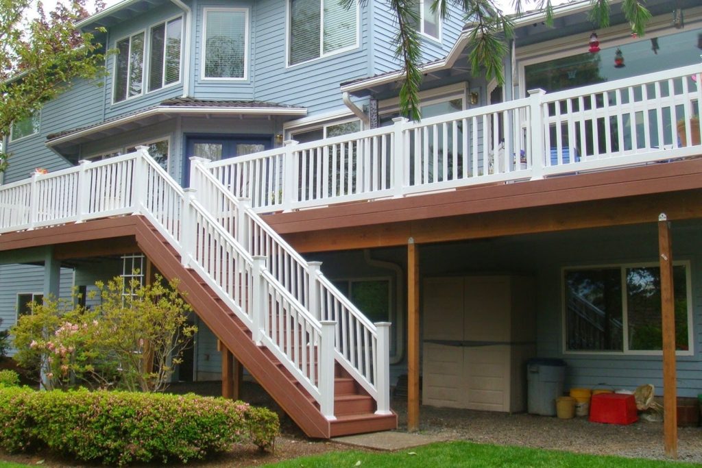 1018 Vinyl Handrails. White vinyl railing on composite deck and stairs