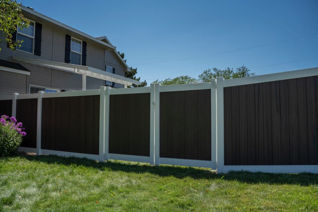 Vinyl fence with white posts and rails and brown boards