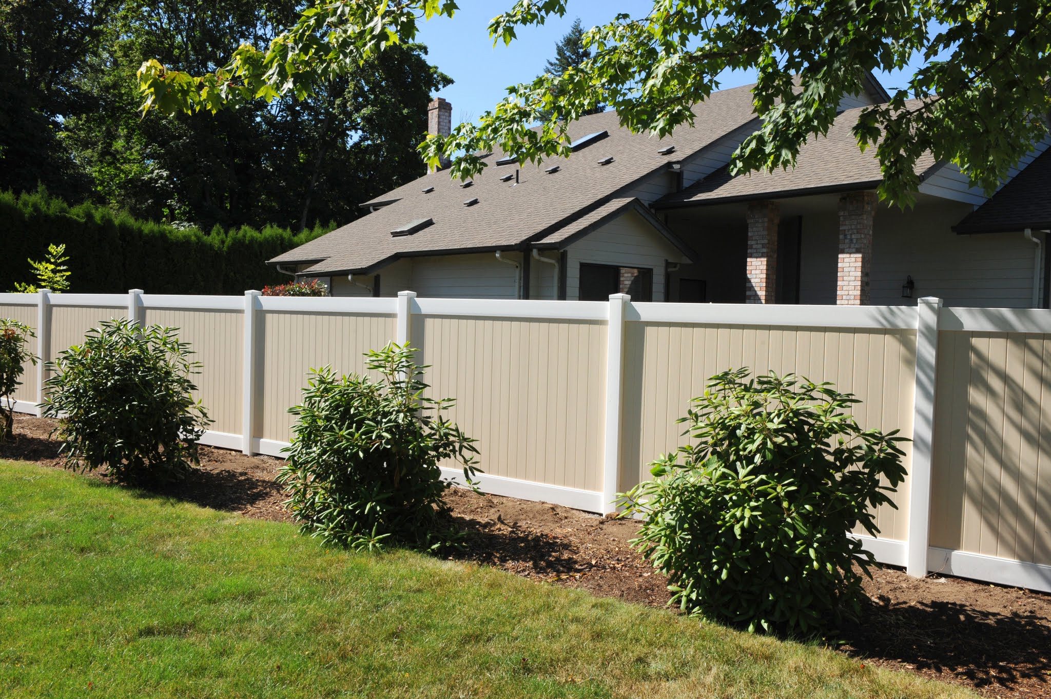 Tan and white Vinyl fence