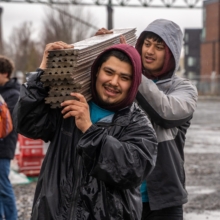 Men carrying decking materials