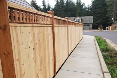 1031 Fencing Cedar Lattice Top A cedar lattice top fence running along a sidewalk.
