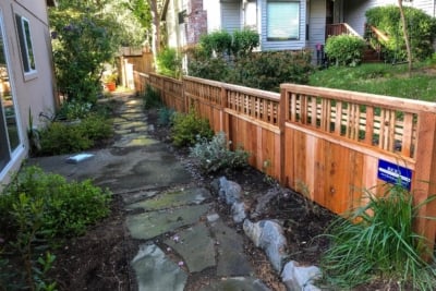 1036 Fencing Cedar Lattice Top A short Catalina lattice top fence running along a stone walkway.