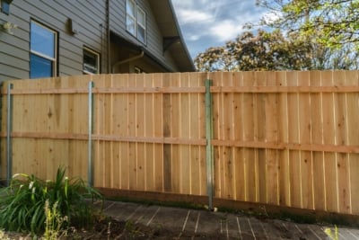 1000 Cedar Solid Style Fencing Solid style fence with metal posts and retaining wall