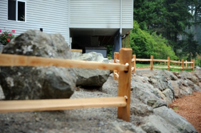 1001 Cedar Split Rail Fencing Cedar Split Rail perimeter fencing over rocky landscaping.