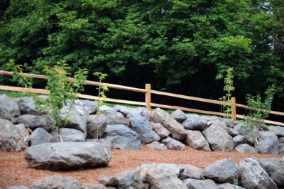 1014 Cedar Split Rail Fencing Cedar split rail fencing with rocks in the foreground.