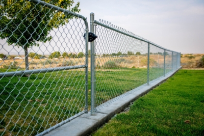 1039 Chain Link Fencing Galvanized chain link fencing with a gate.