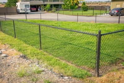 1044 Chain Link Fencing Chain link fence corner around a lawn.
