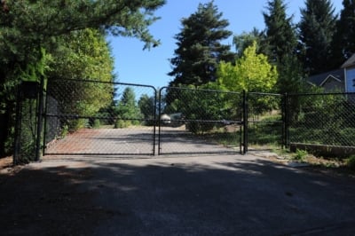 1047 Chain Link Fencing Black chain link double drive and single swing gates.