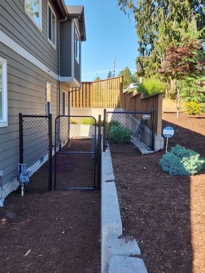 1053 Chain Link Fencing A black chain link fence with a gate.