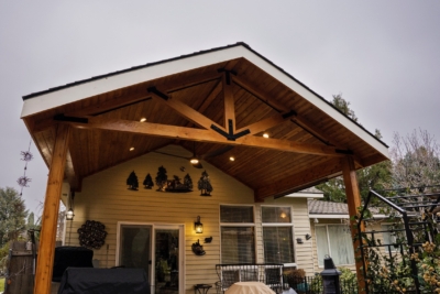 1108 Covers Wood Framed A wooden patio cover covering a patio filled with patio furniture.