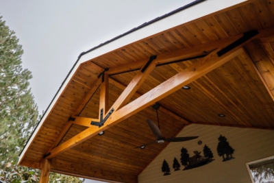1109 Covers Wood Framed A wooden gable patio cover with tree decoraction.